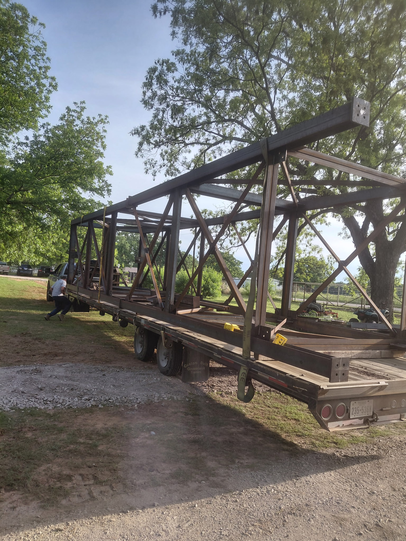 Structural steel truss loaded on a gooseneck trailer for transport